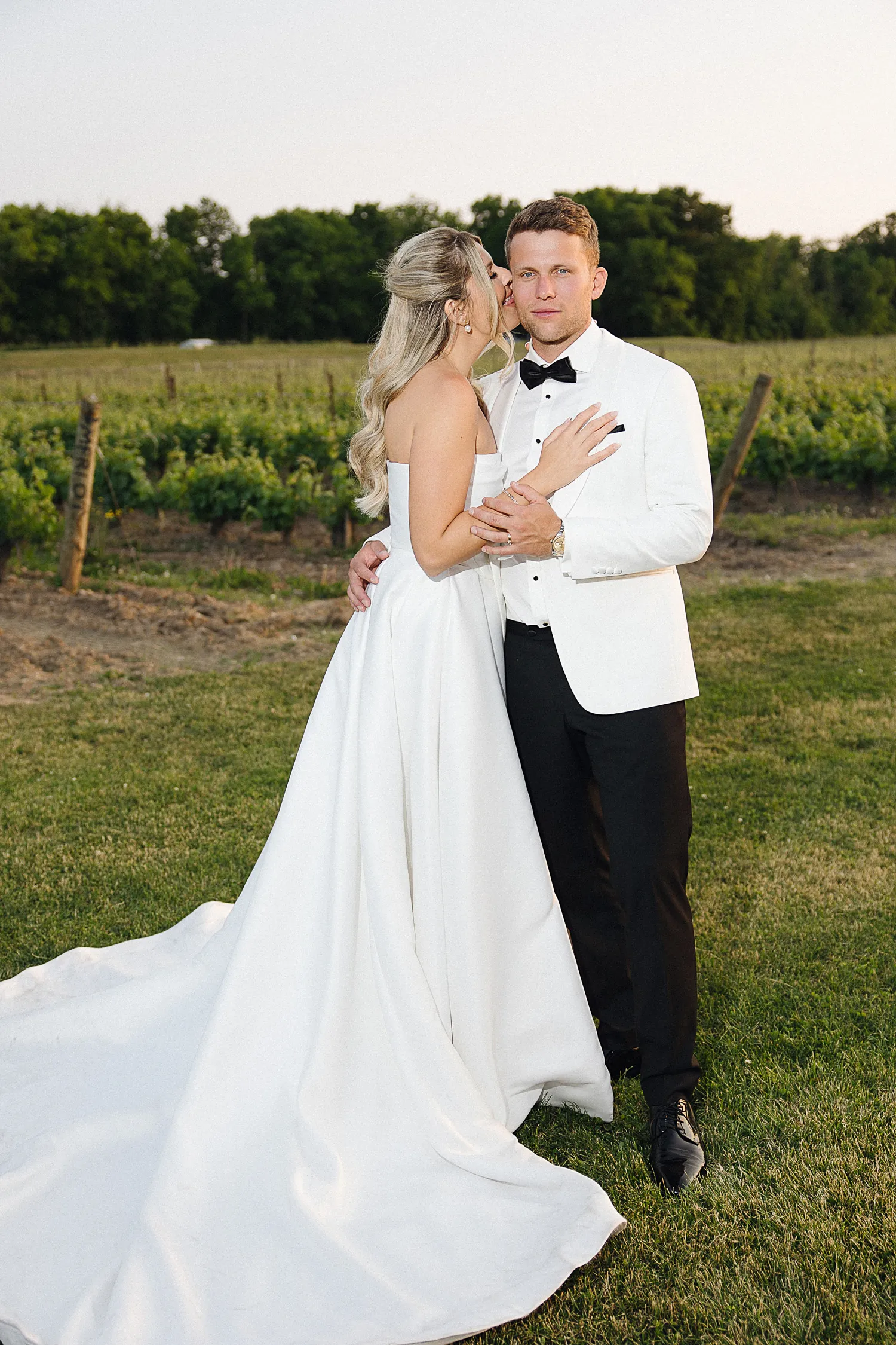 Flash photo of couple kissing in vineyard
