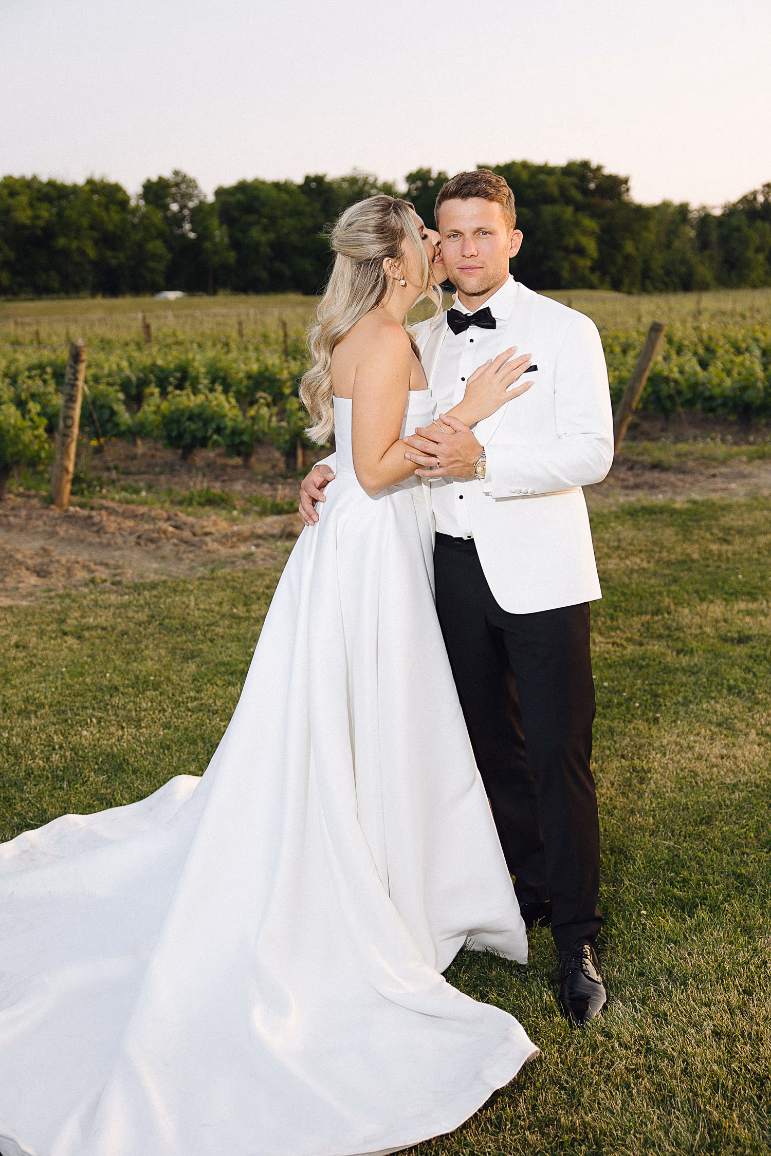 Flash photo of couple kissing in vineyard