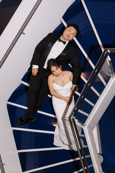 couple posing of stairs at Aga Khan Museum