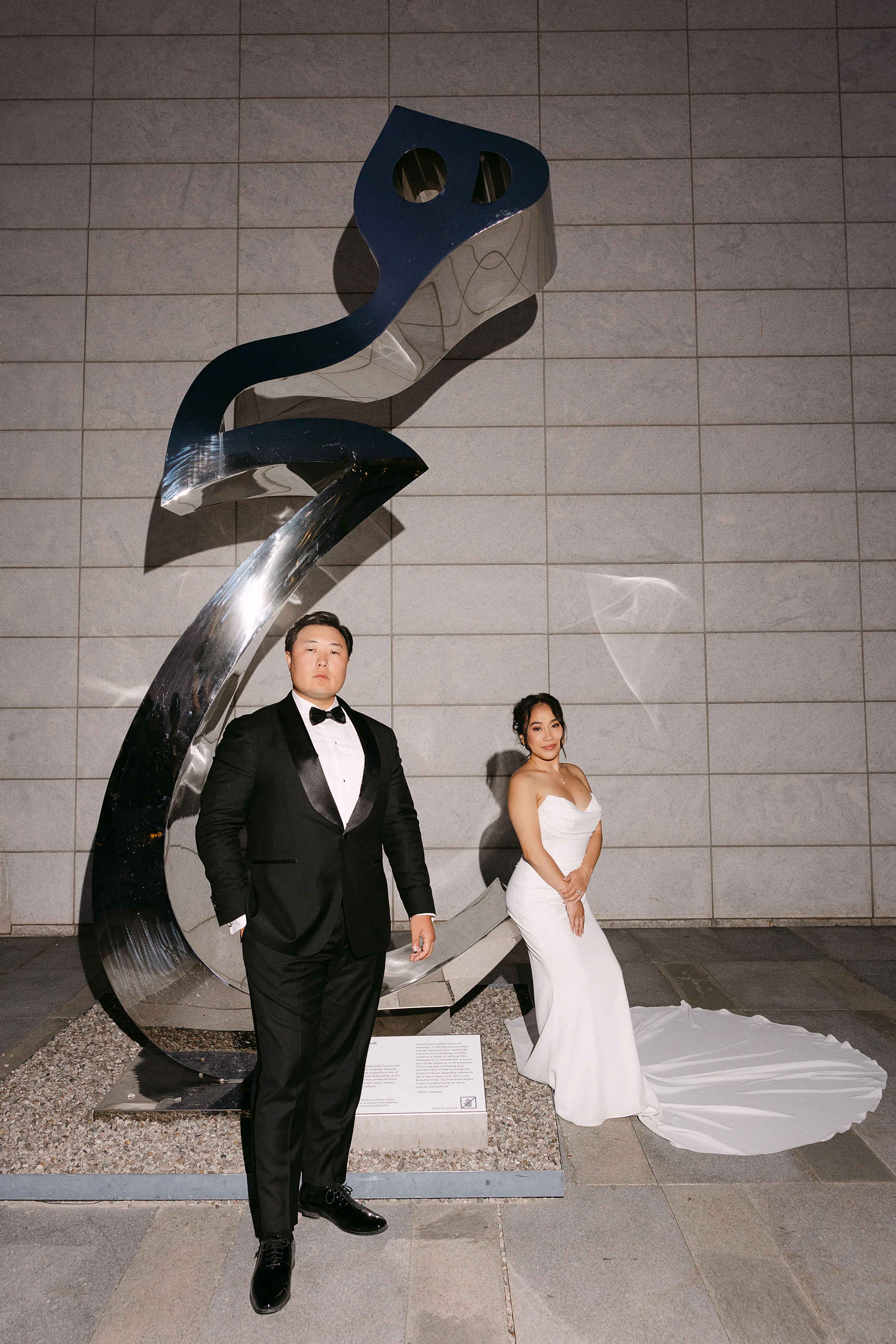 Couple posing at Aga Khan white stone facade