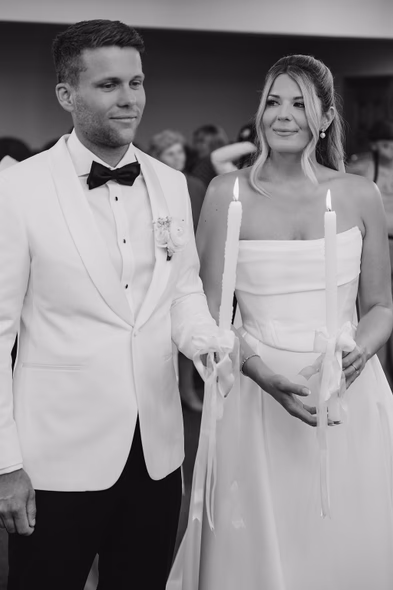 Bride and groom holding candles during church ceremony at Niagara-on-the-Lake winery wedding