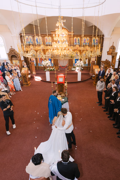 Orthodox ceremony during Chateau des Charmes wedding with guests inside church