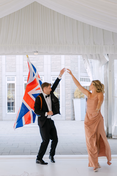 Couple dancing with flag during Chateau des Charmes wedding reception