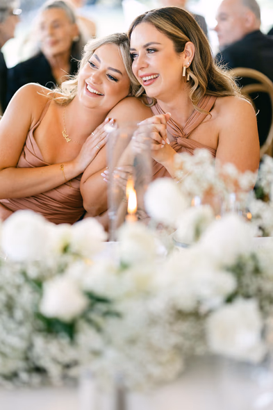 Bridesmaids laughing during dinner at Niagara-on-the-Lake winery wedding