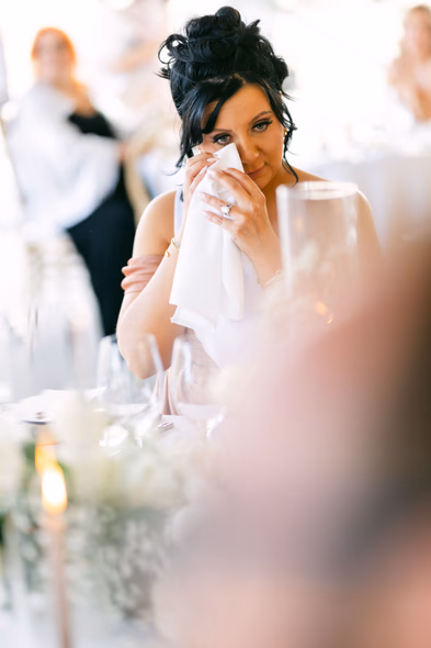 Emotional bride wiping tears during speech at Niagara-on-the-Lake winery wedding
