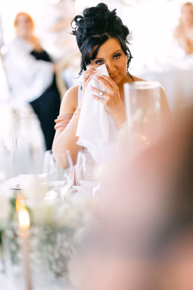 Emotional bride wiping tears during speech at Niagara-on-the-Lake winery wedding