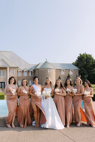 Chateau des Charmes wedding photos with bride and bridesmaids by fountain