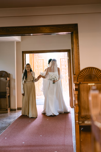 Bride walking with bridesmaid during wedding morning at Niagara-on-the-Lake wedding photography session