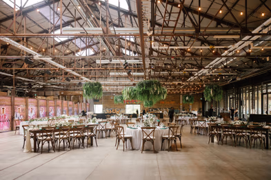 groom posing with bride at Evergreen Brickworks