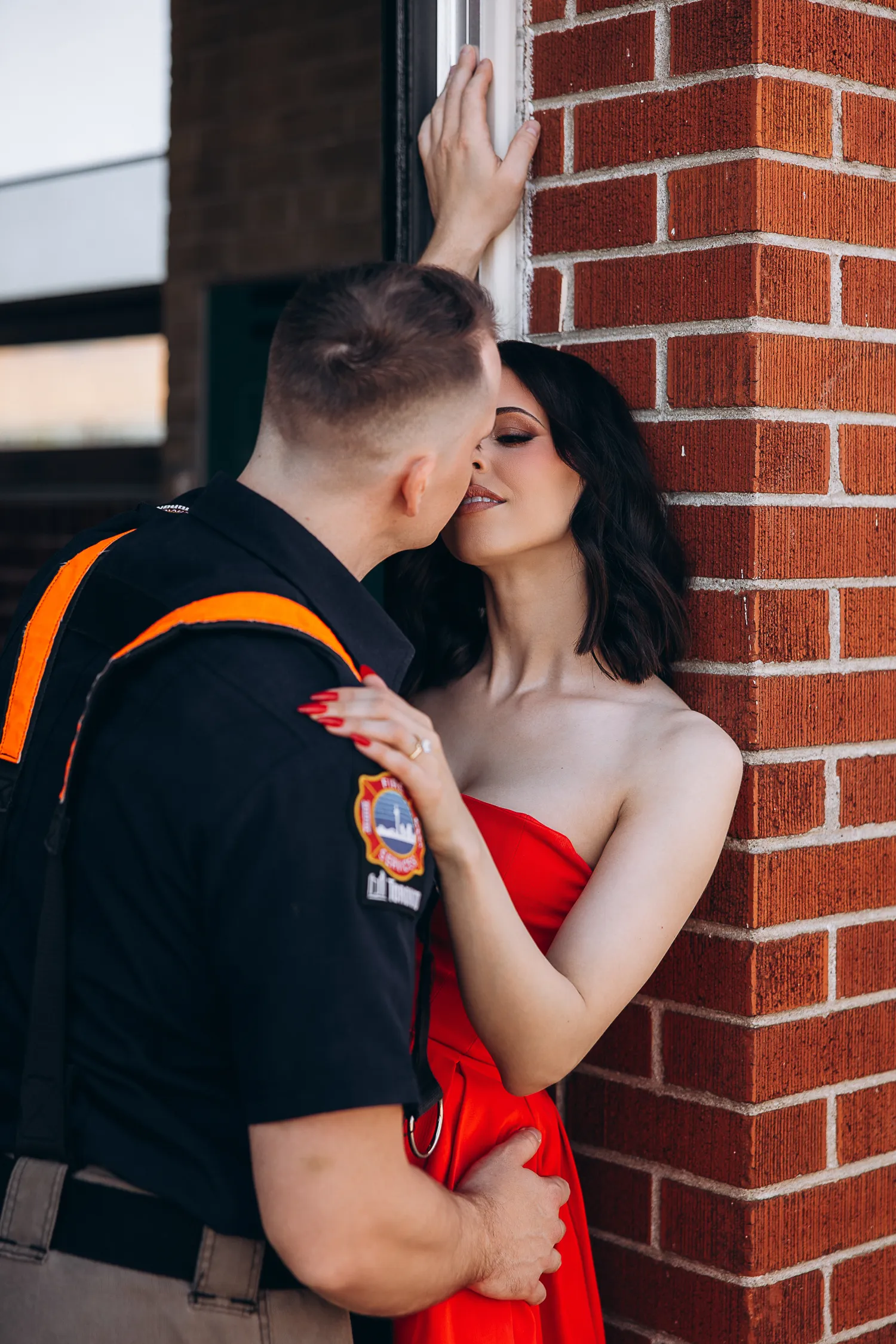 couple posing by fire truck
