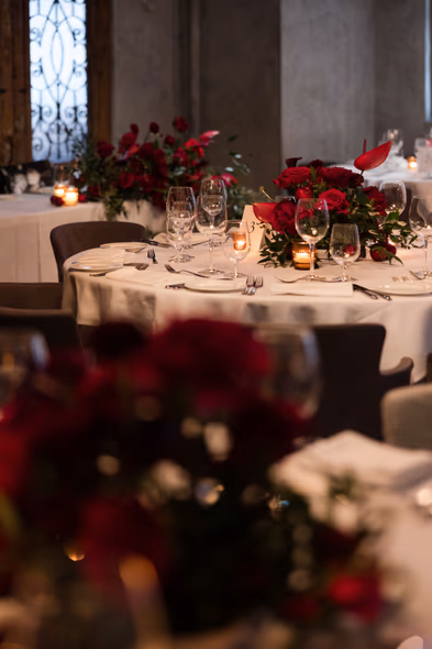 Wedding table decor at George Restaurant Toronto with red floral centerpiece