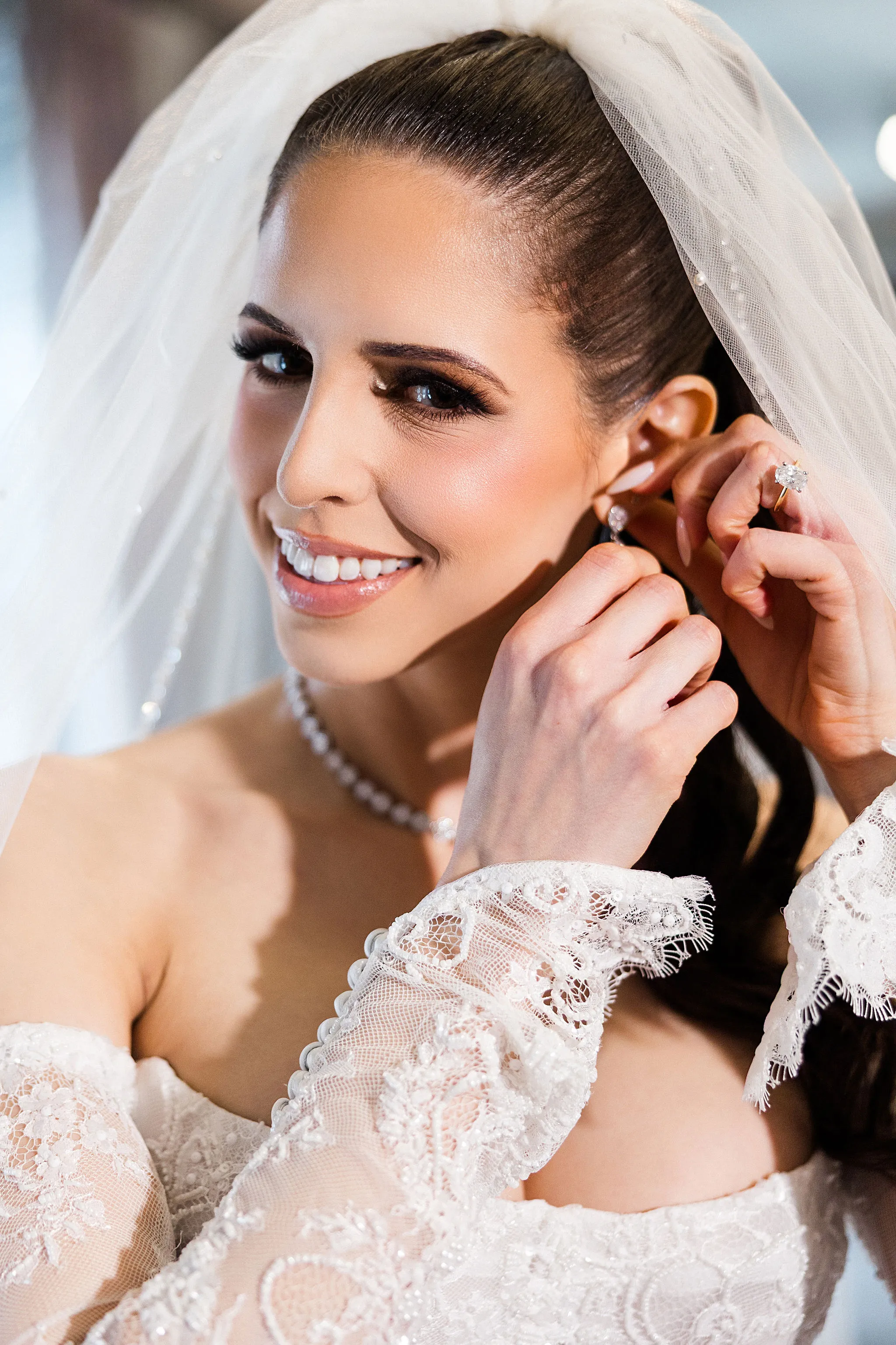 Bride putting on earrings wedding