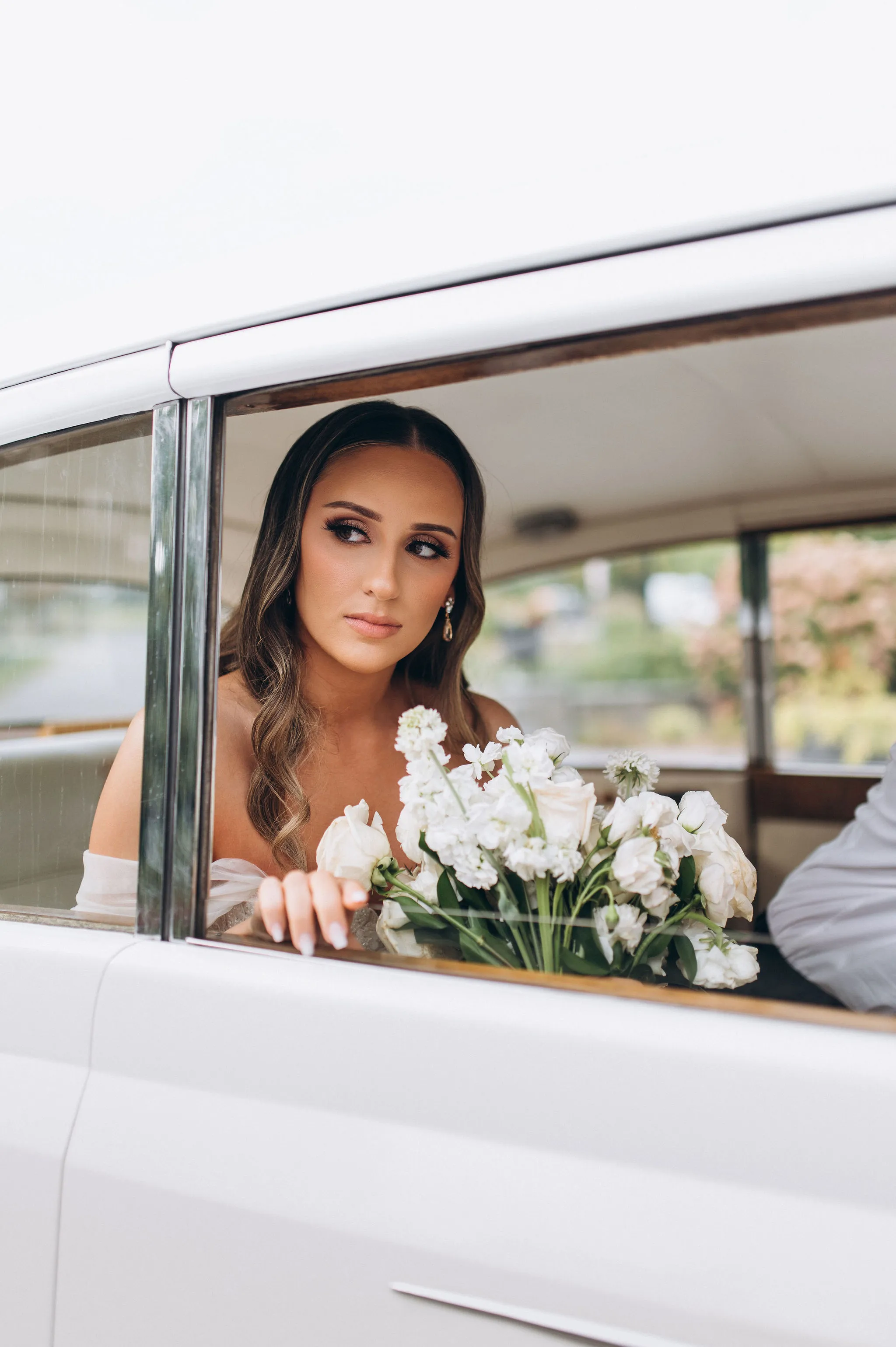 bride sitting in vintage car afer Knox College ceremony