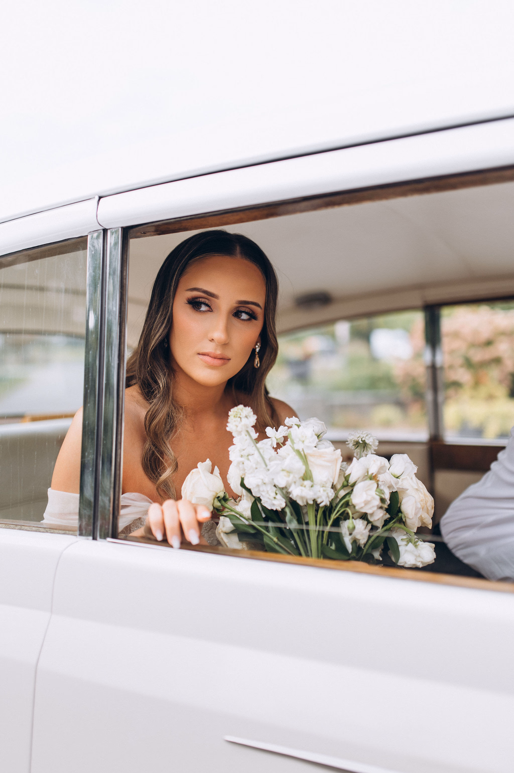 bride sitting in vintage car afer Knox College ceremony