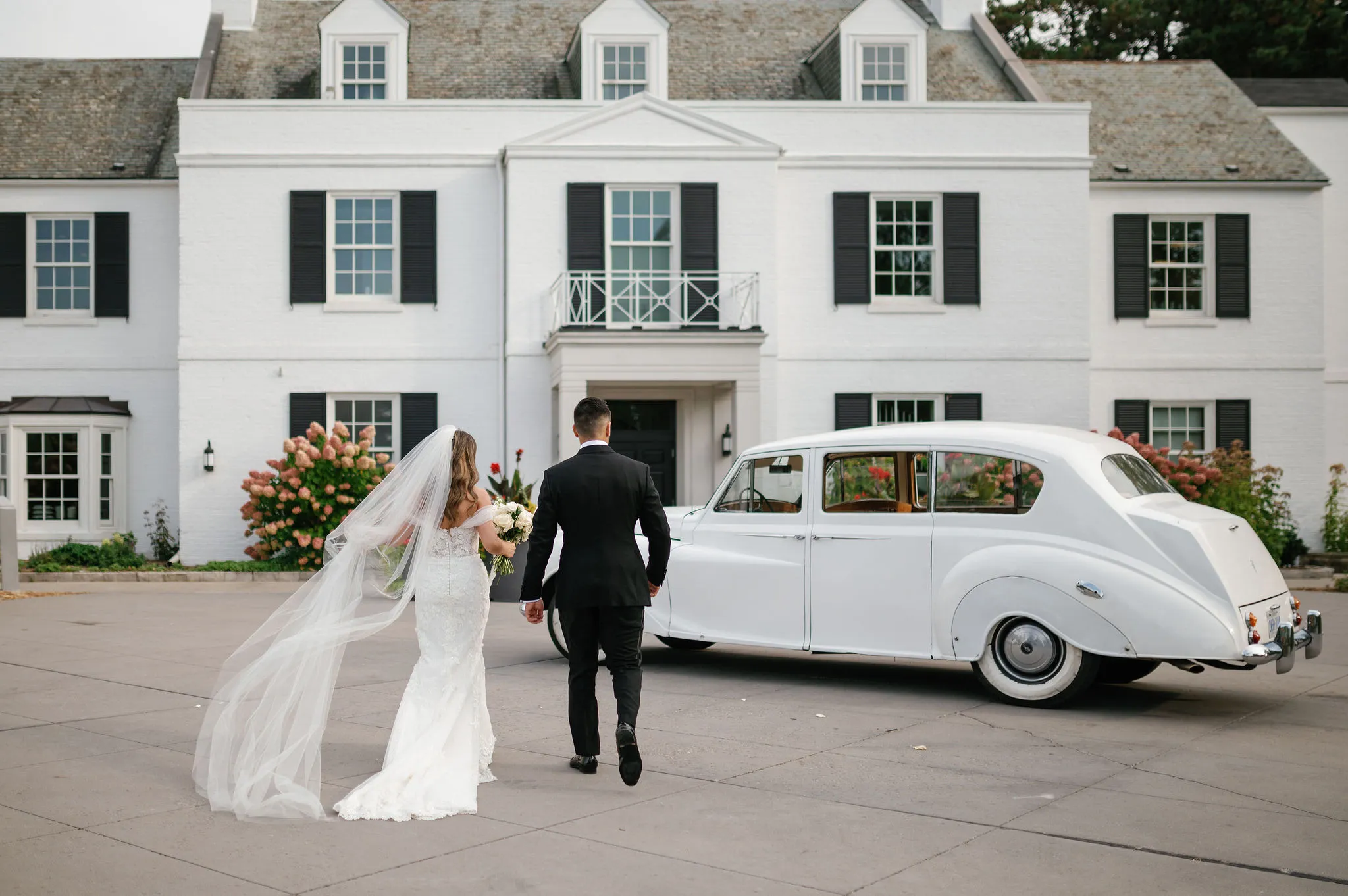 Harding Waterfront Estate brida and groom with a car