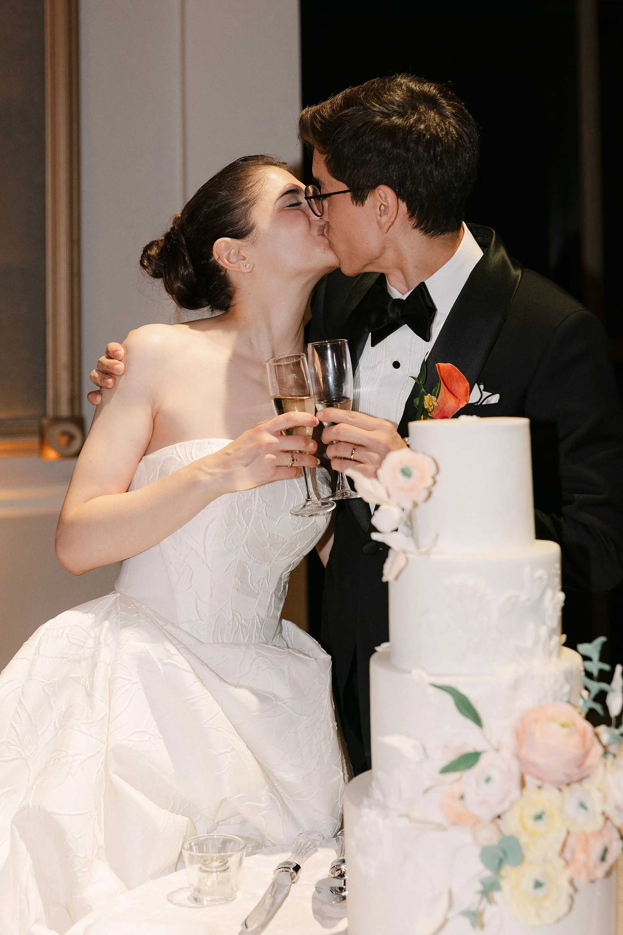 couple cut the cake at reception at Liberty Grand