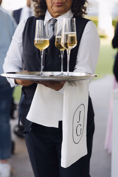 Server carrying tray of champagne at Lido House wedding