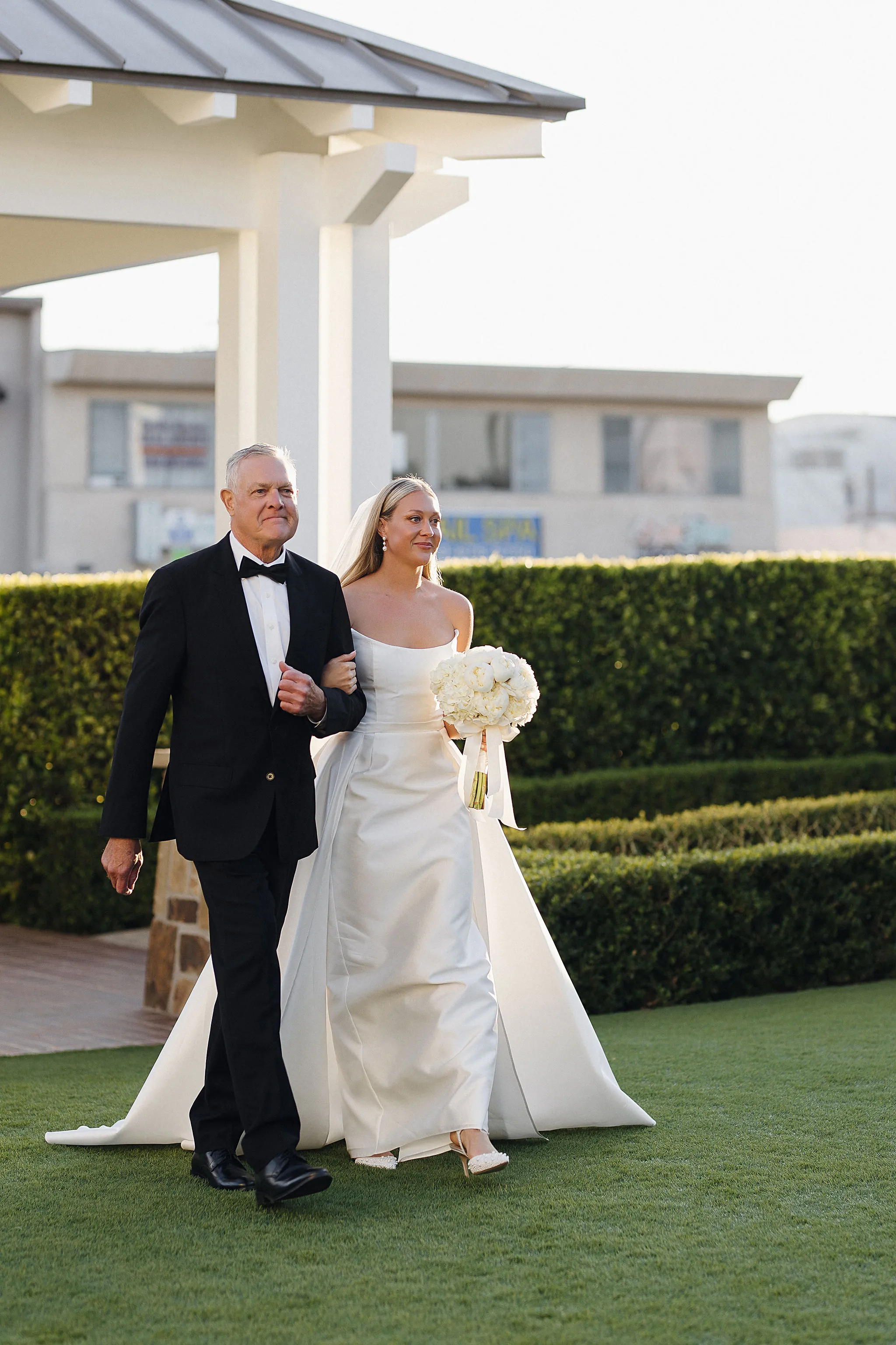 Bride walking down the aisle with her father at Lido House wedding