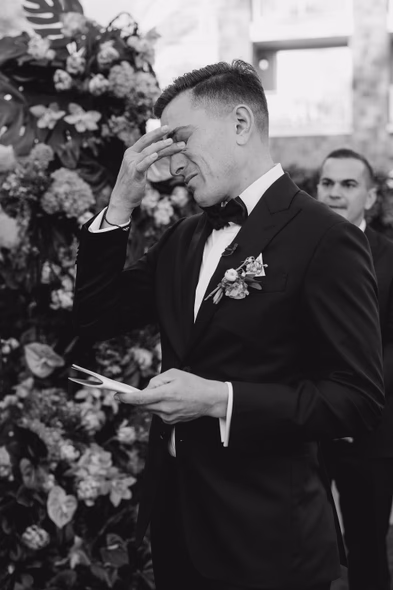 Emotional groom with a hand on his face during Lido House wedding vows