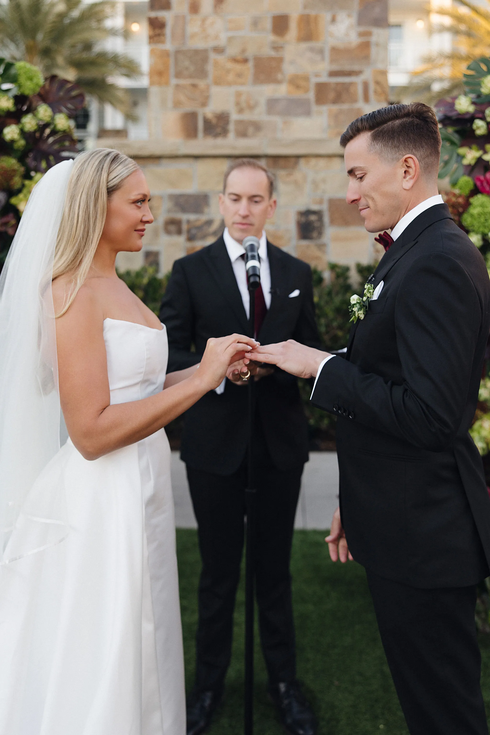 Bride placing ring on groom’s finger during Lido House ceremony