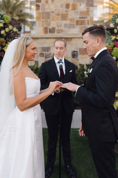 Bride placing ring on groom’s finger during Lido House ceremony