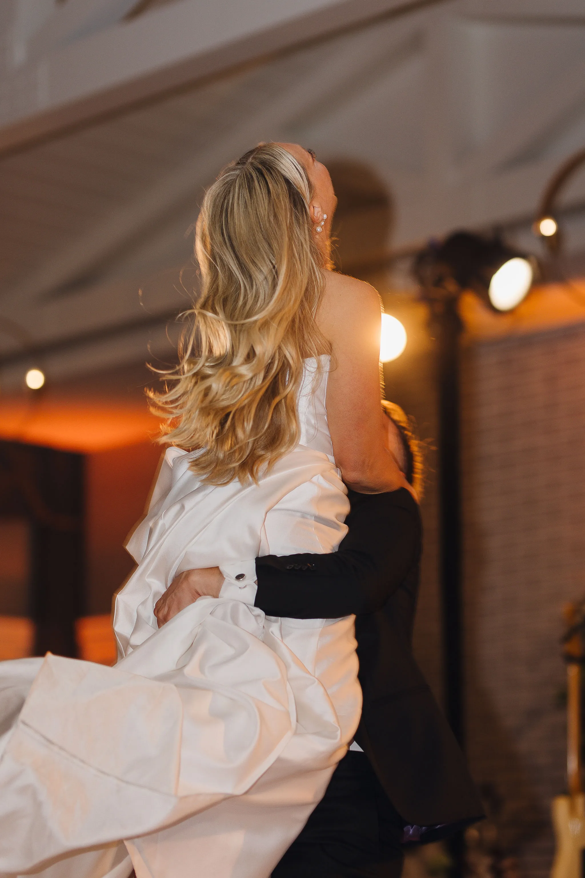 Bride being lifted in the air during lively wedding celebration at Lido House