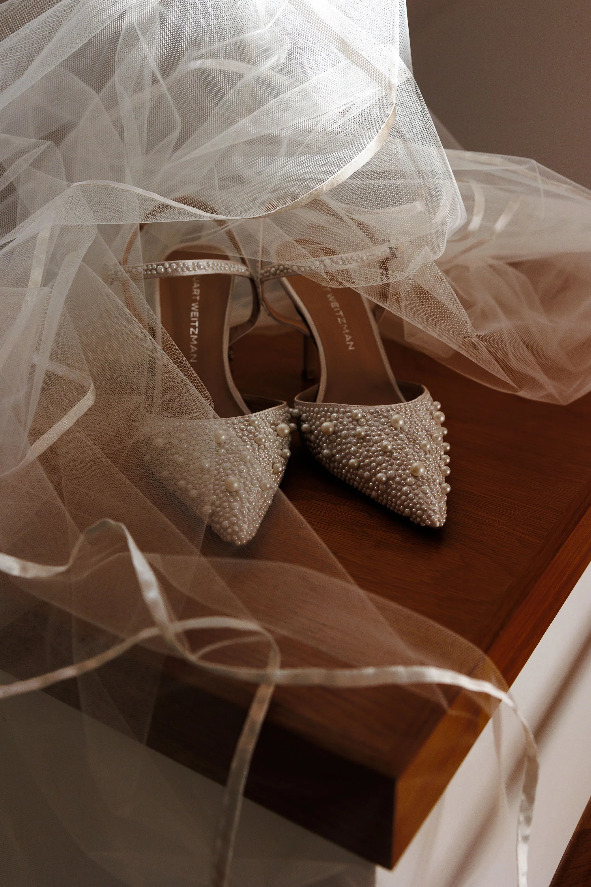 Bridal shoes adorned with jewels, placed under veil at Lido House