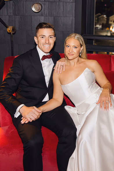 Newlyweds sitting together with happy expressions at Lido House