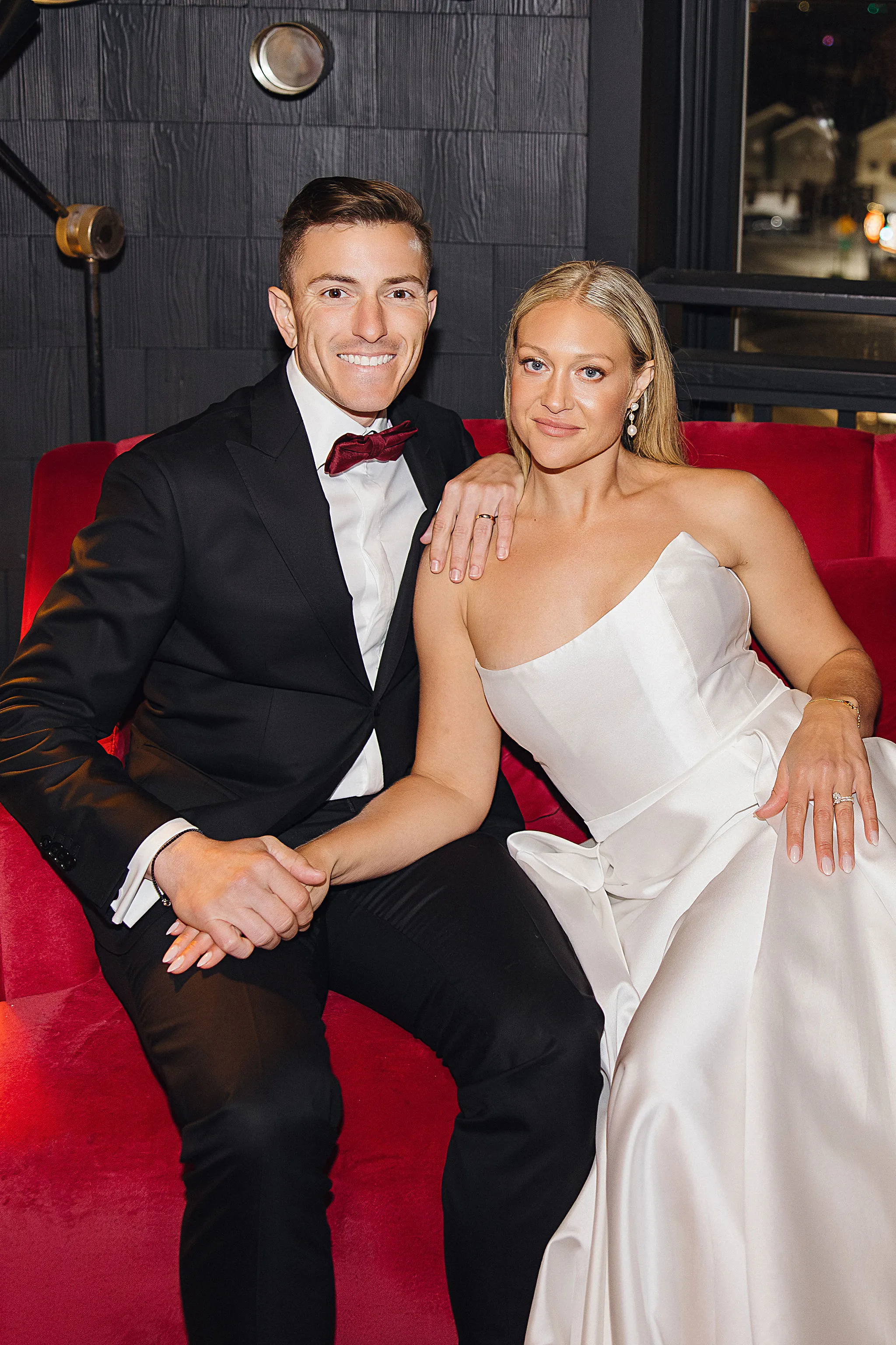 Newlyweds sitting together with happy expressions at Lido House