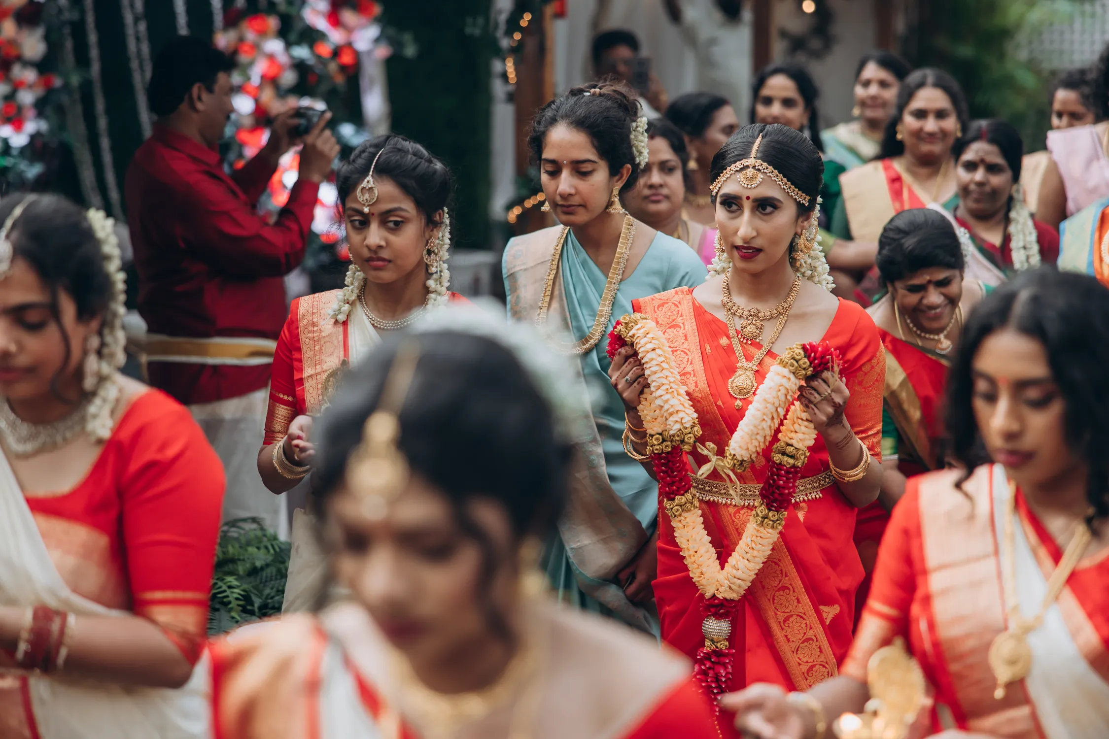 Bridal party in red sarees arriving for Tamil wedding at greenhouse venue Toronto
