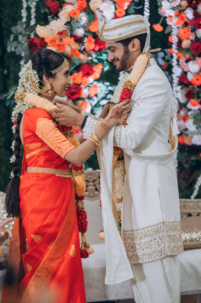 Bride and groom exchanging garlands at Tamil wedding ceremony in Toronto greenhouse venue