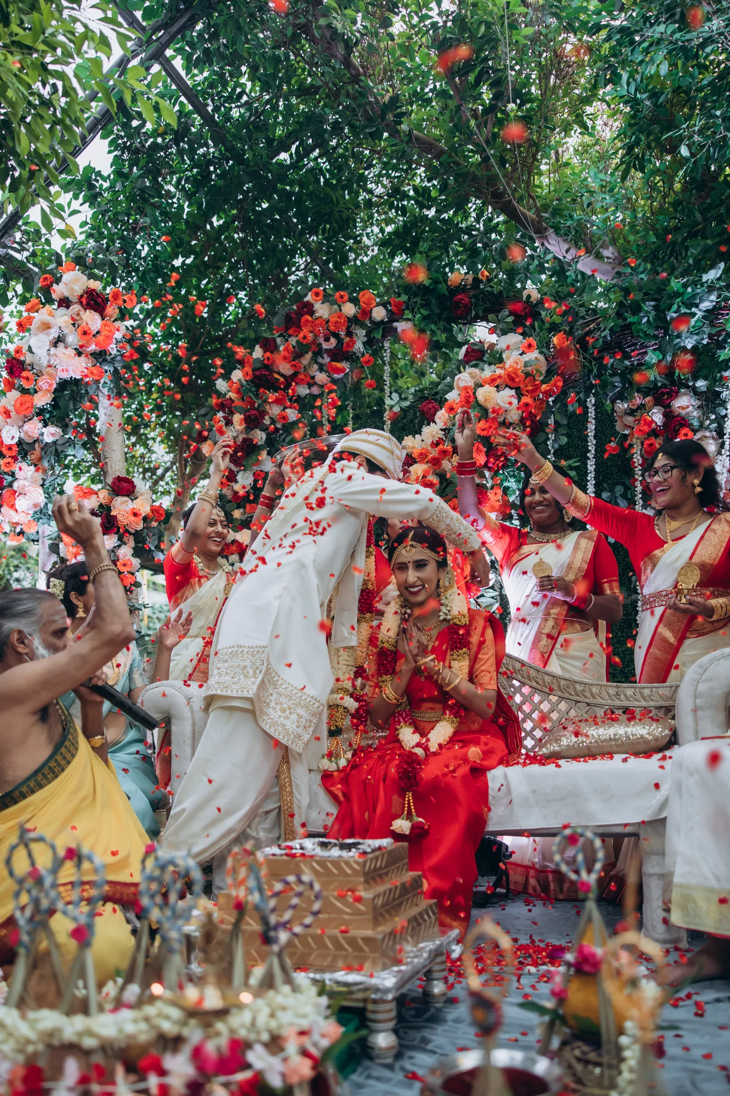 Tamil Hindu wedding rituals with family under floral mandap at Madison Greenhouse wedding