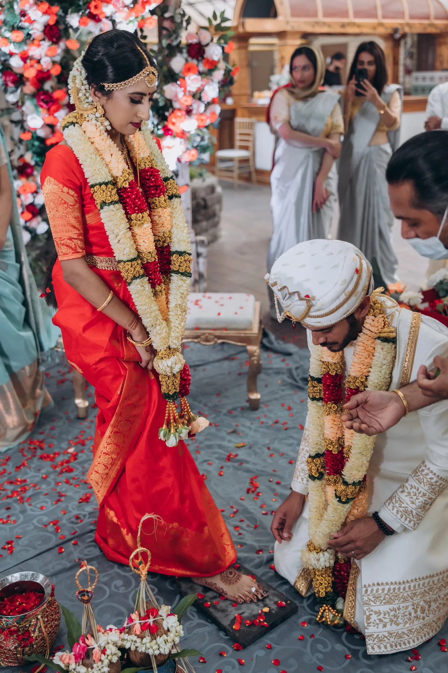 Couple performing fire ritual at Tamil Hindu wedding in greenhouse wedding venue