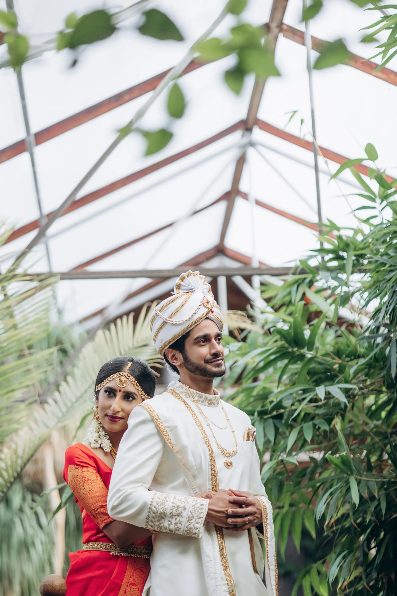 Couple portrait under glass roof at Madison Greenhouse wedding venue in Ontario