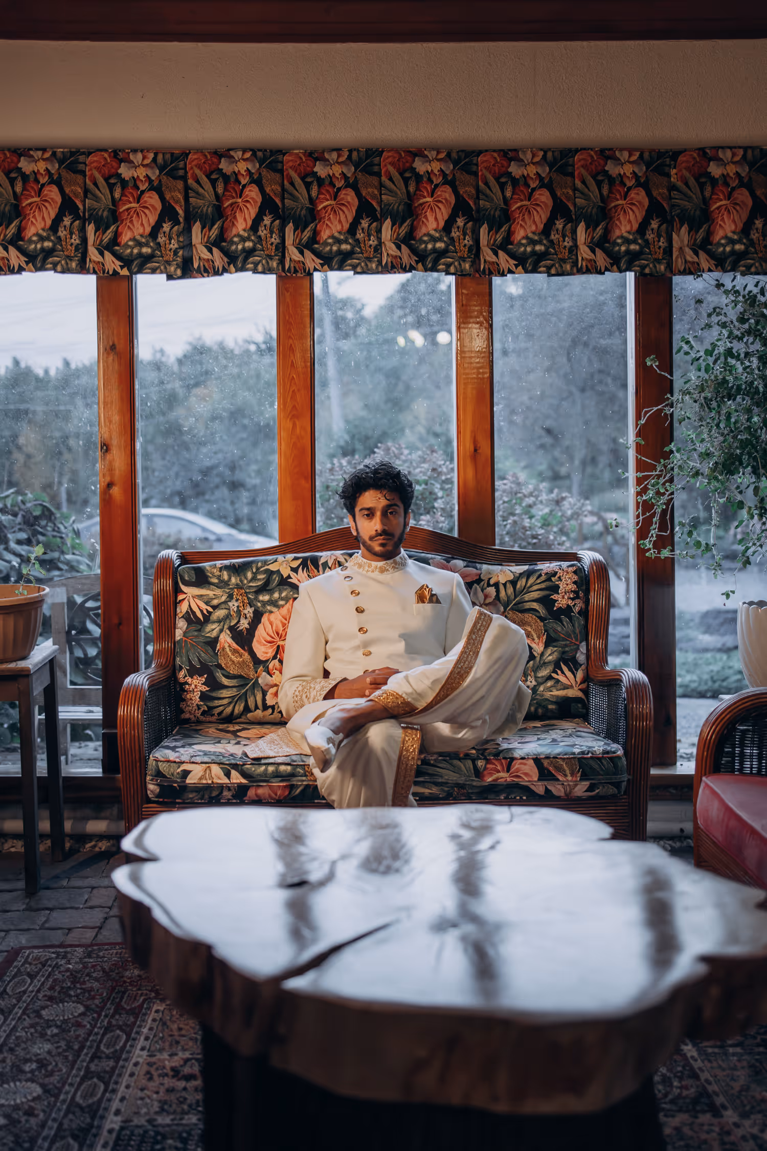Groom sitting indoors in traditional attire before Madison Greenhouse Tamil wedding