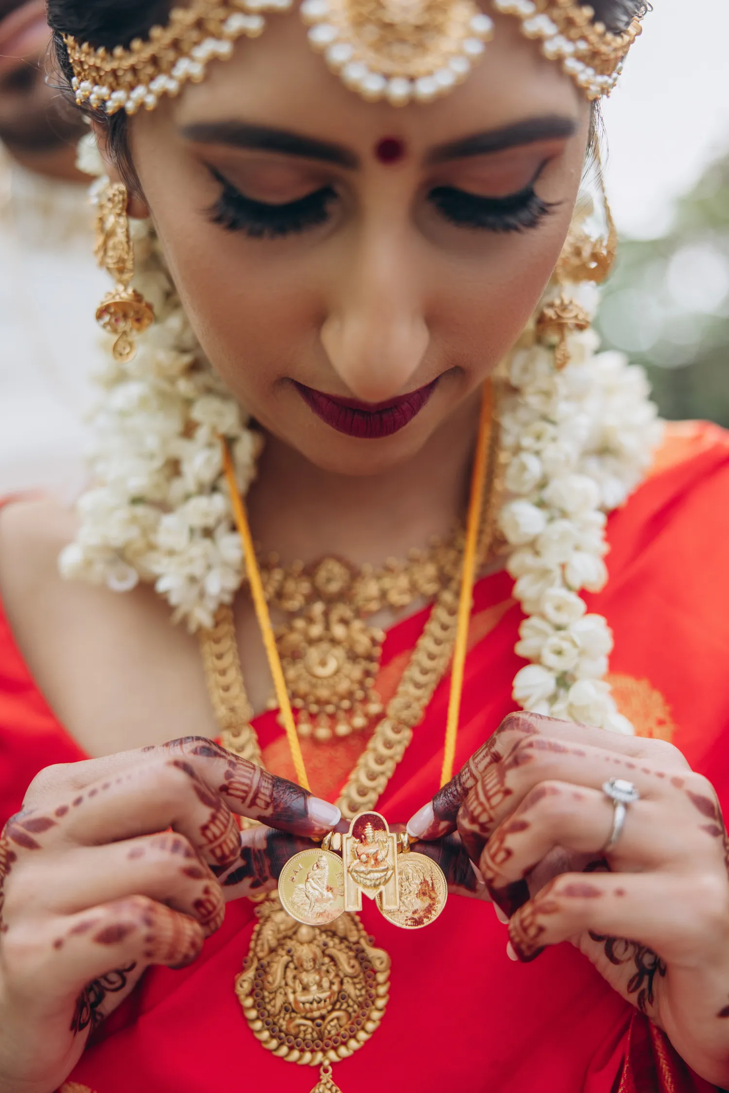 Bride holding thaali necklace during Tamil Hindu wedding ceremony