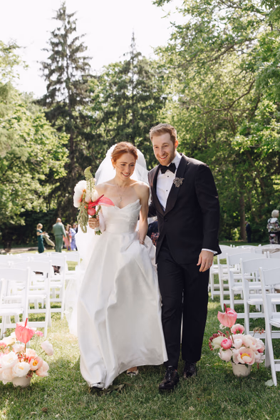newlyweds walking down the aisle just married outdoor garden wedding Queen’s Landing