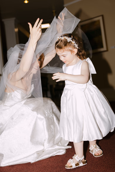 flower girl dancing with veil joyful candid wedding reception moment