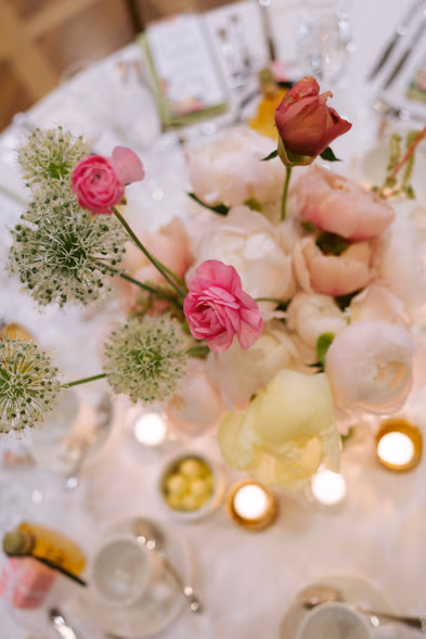 romantic floral flat lay pink roses candles wedding reception details Queen’s Landing