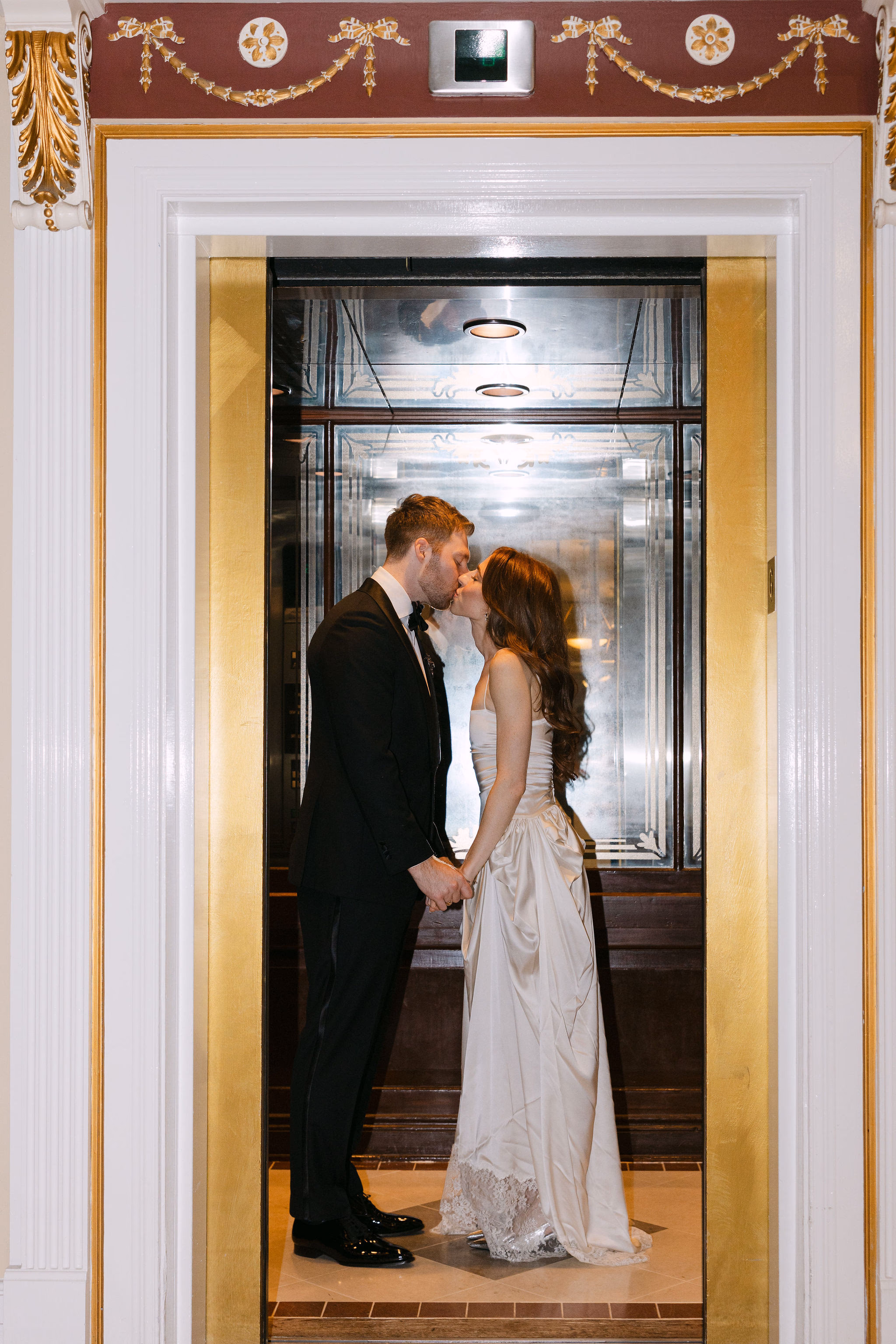 bride and groom’s kissing at elevator at Queen’s Landing Hotel in Niagara-on-the-Lake
