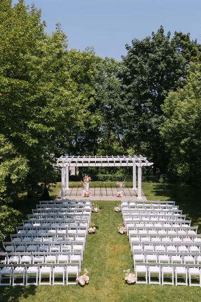 outdoor ceremony setup aisle chairs garden Queen’s Landing Niagara-on-the-Lake wedding venue