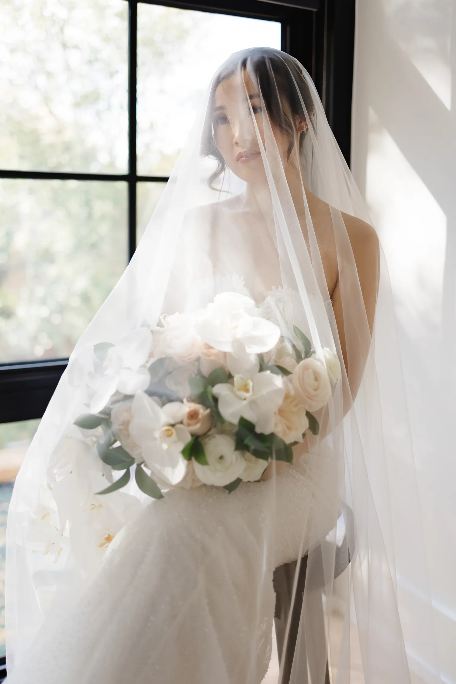 Smiling bride under sheer veil