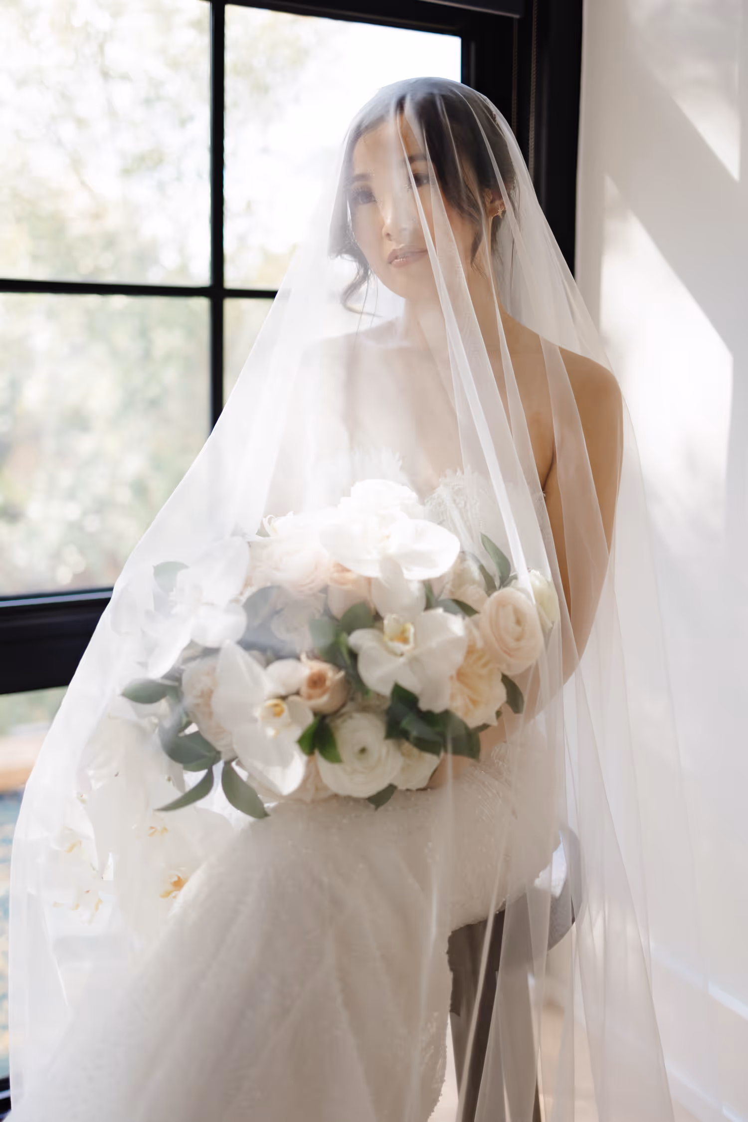 Smiling bride under sheer veil