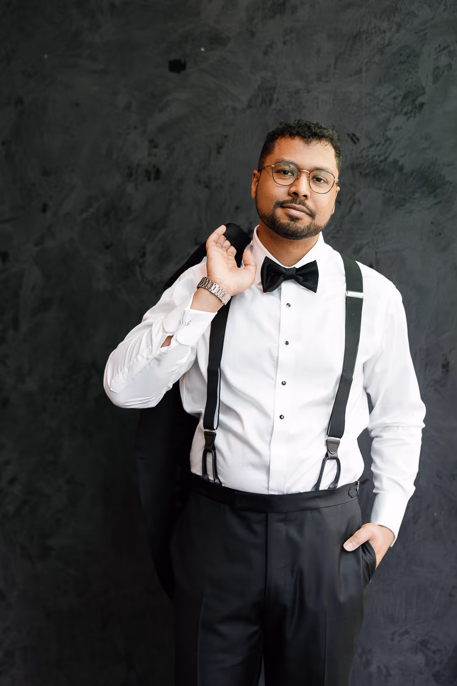 groom posing with jacket