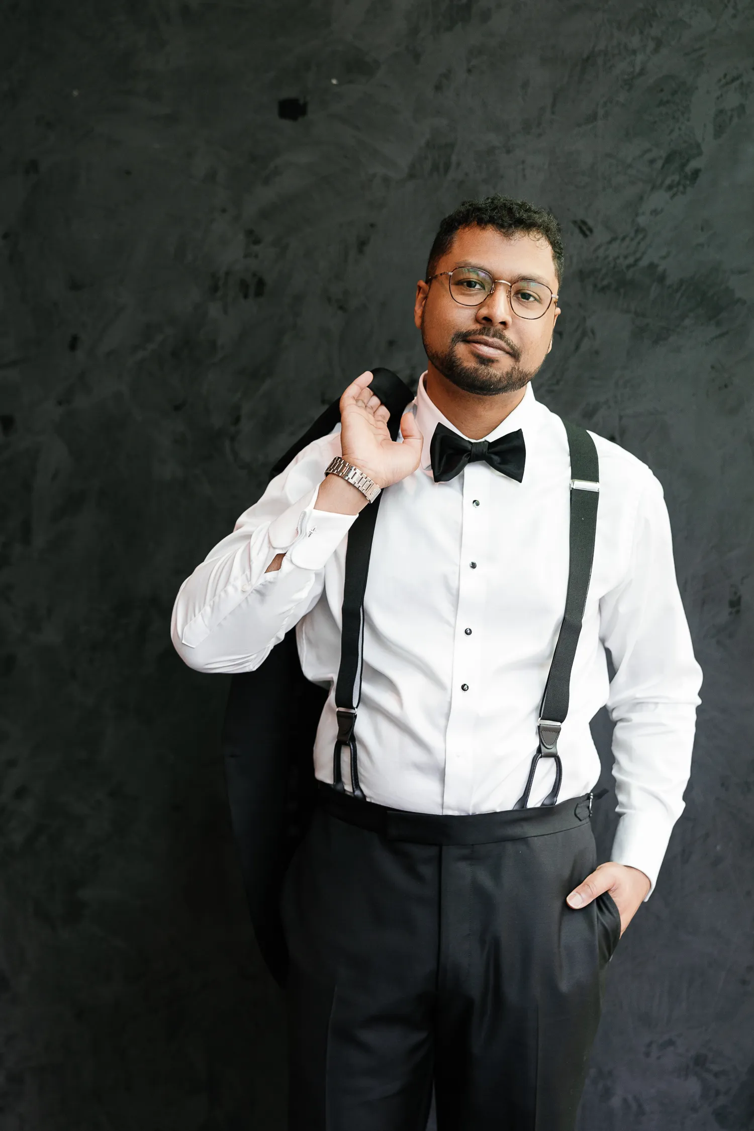 groom posing with jacket