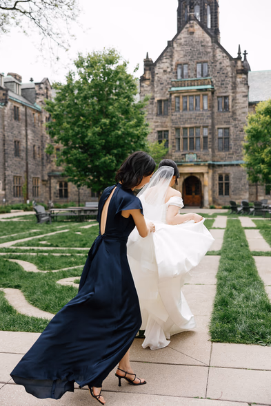 bride with bridesmaid at Trinity College garden